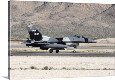 An F-16C Aggressor jet landing on runway in Nevada