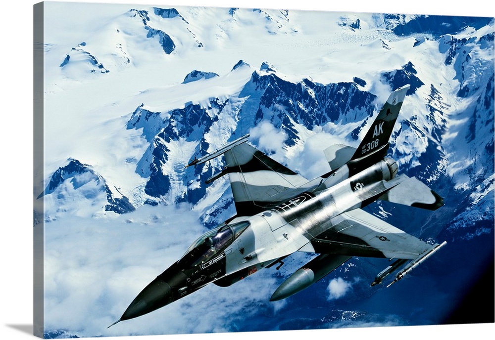 An F-16C Falcon from the 18th Aggressor Squadron flies over an Alaskan mountain range.