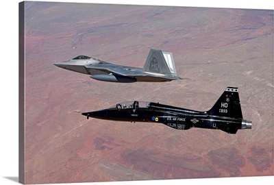 An F-22 Raptor and a T-38 Talon fly in formation over New Mexico