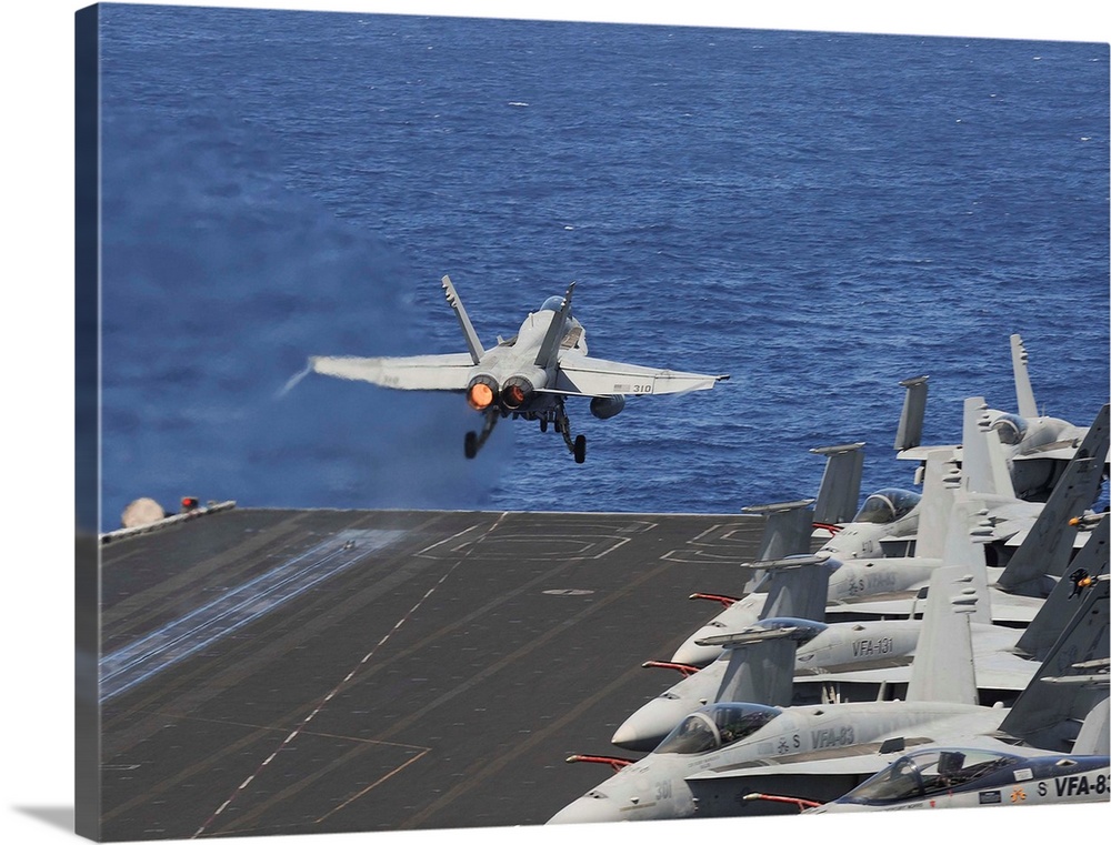 North Arabian Sea, June 5, 2013 - An F/A-18C Hornet launches off the flight deck of the aircraft carrier USS Dwight D. Eis...