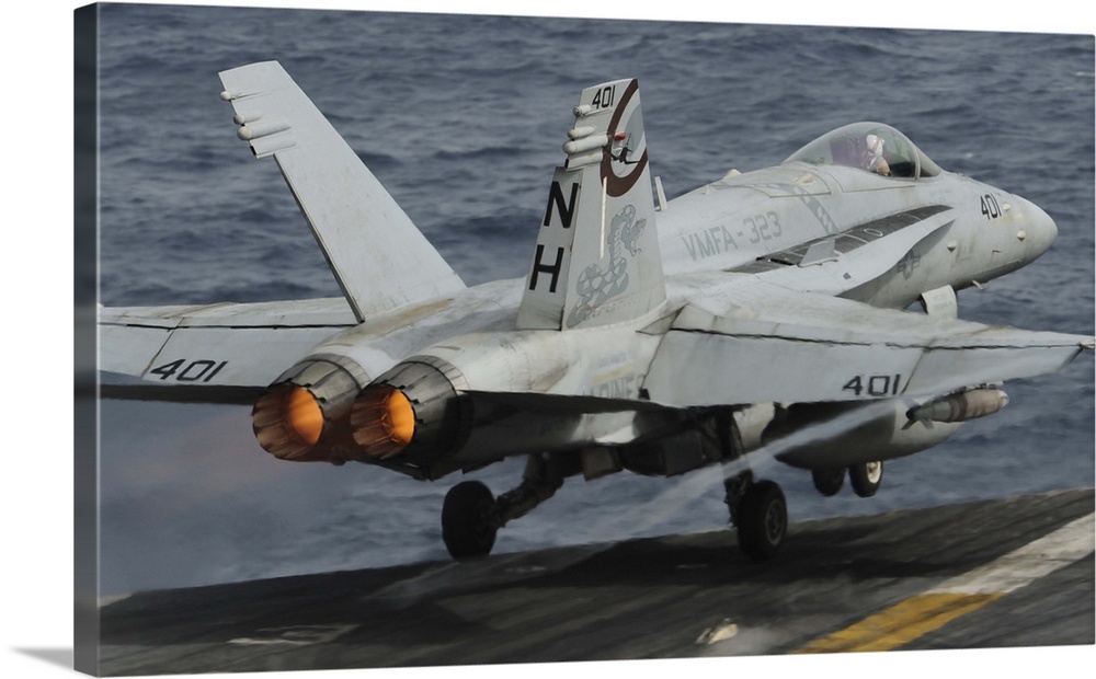 Gulf of Oman, July 1, 2013 - An F/A-18C Hornet launches off the flight deck of the aircraft carrier USS Nimitz.