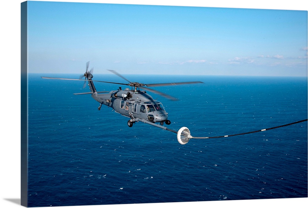 Pacific Ocean, March 18, 2011 - An MC-130P Combat Shadow refuels a HH-60 Pave Hawk helicopter. The refueling missions are ...