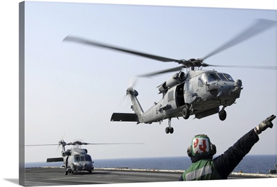 An HH-60H Sea Hawk helicopter takes off from USS Ronald Reagan