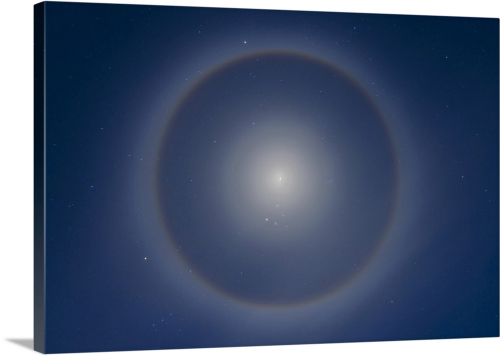 An ice crystal halo around the waxing gibbous Moon set in the winter stars of a January night