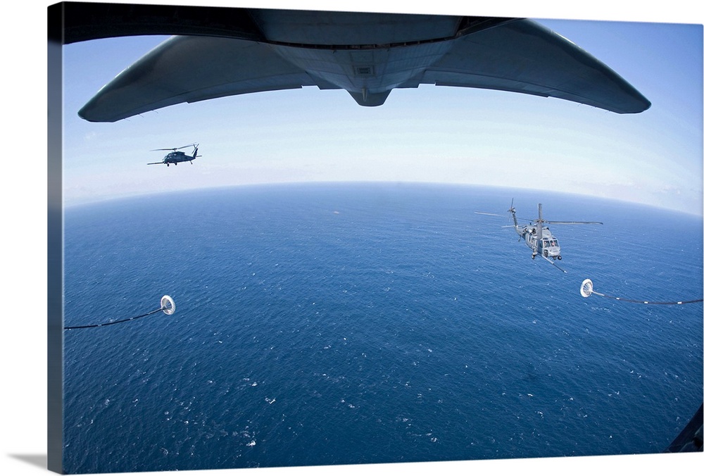 March 18, 2011 - An MC-130P Combat Shadow crew prepares to refuel two HH-60G Pave Hawk helicopters above the Pacific Ocean.