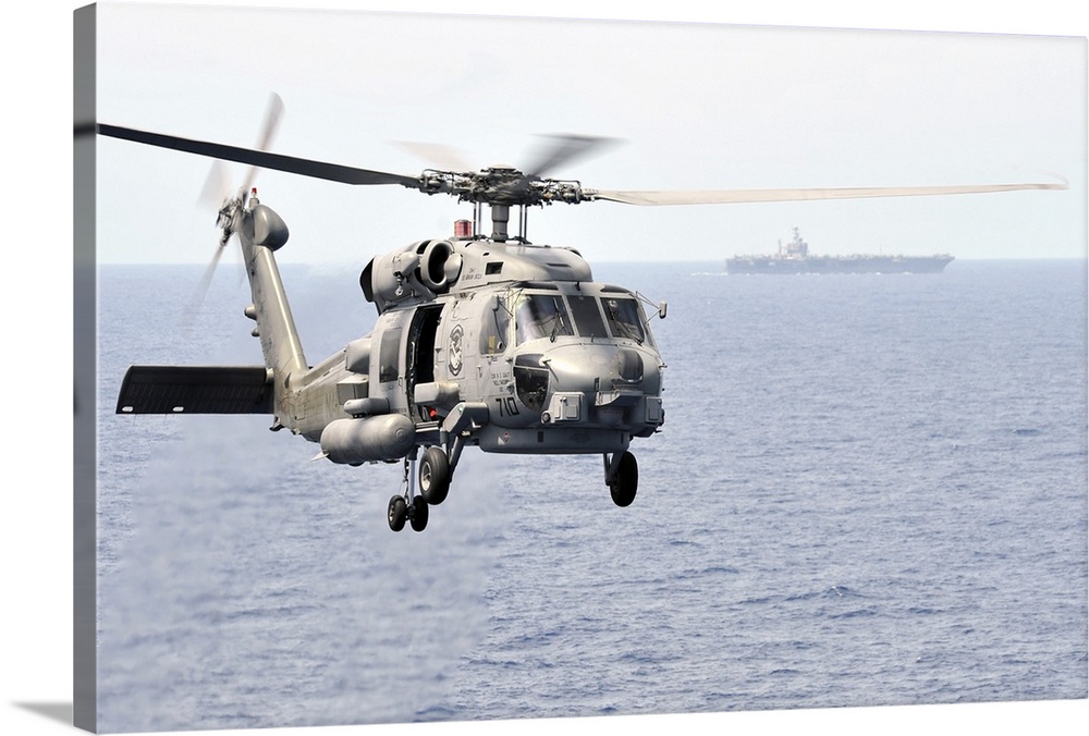 Pacific Ocean, March 9, 2011 - An MH-60R Seahawk helicopter participates in an air power demonstration while embarked aboa...
