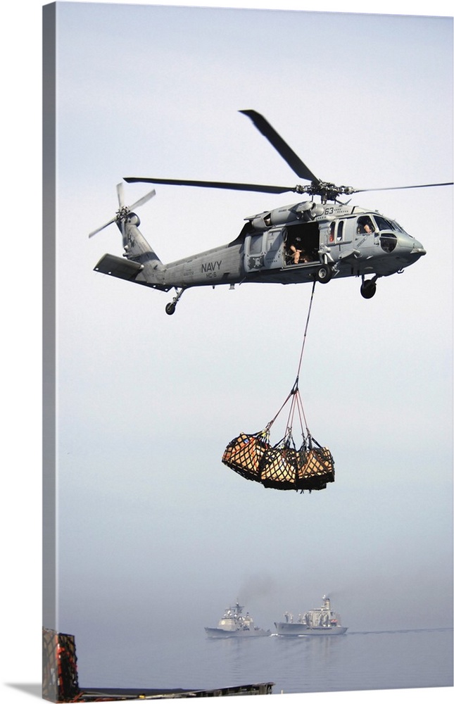 An MH-60S Knighthawk delivering cargo.