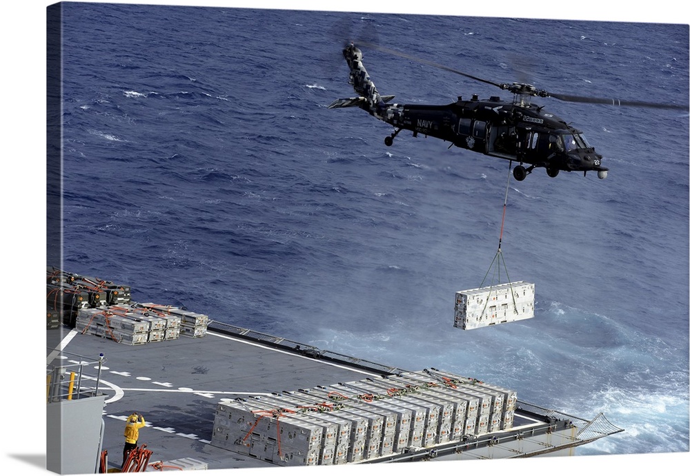Atlantic Ocean, January 15, 2013 - An MH-60S Sea Hawk helicopter picks up ammunition from the Military Sealift Command dry...