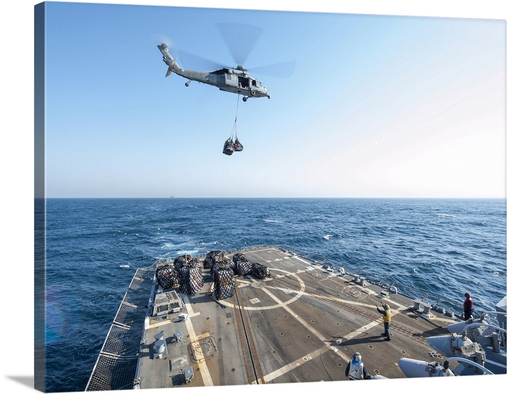 An MH-60S Seahawk helicopter drops supplies aboard USS Truxton.