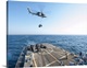 image thumbnail of An MH-60S Seahawk helicopter drops supplies aboard USS Truxton.