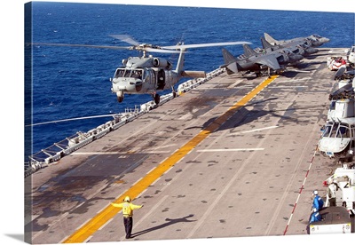 An MH-60S Seahawk helicopter prepares to land aboard USS Makin Island