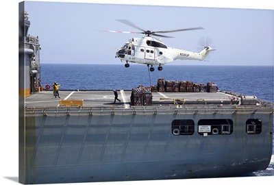 An SA-330J Puma helicopter delivers supplies to USS Kearsarge