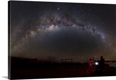 Astronomer with telescope looking at the Milky Way in the Atacama Desert, Chile