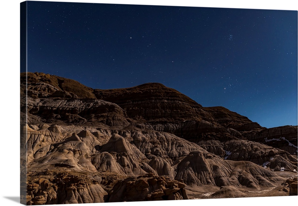 Auriga and Taurus rising in the moonlight at the Hoodoos near Drumheller, Alberta, Canada.