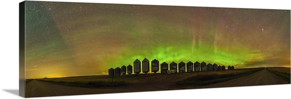 A 180 degree panorama of a modest aurora display behind grain bins on a country road in Alberta, Canada. The aurora adds m...