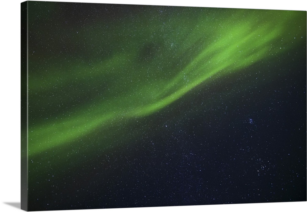 Aurora borealis dances above the Arctic Ocean from Teriberka, Murmansk, Russia.