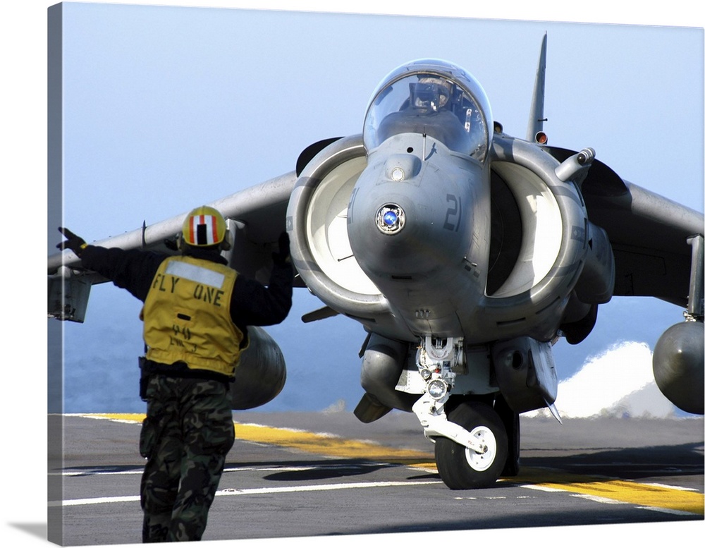 Atlantic Ocean, January 10, 2005 - Aviation Boatswain's Mate directs an AV-8B Harrier to turn right on the flight deck of ...
