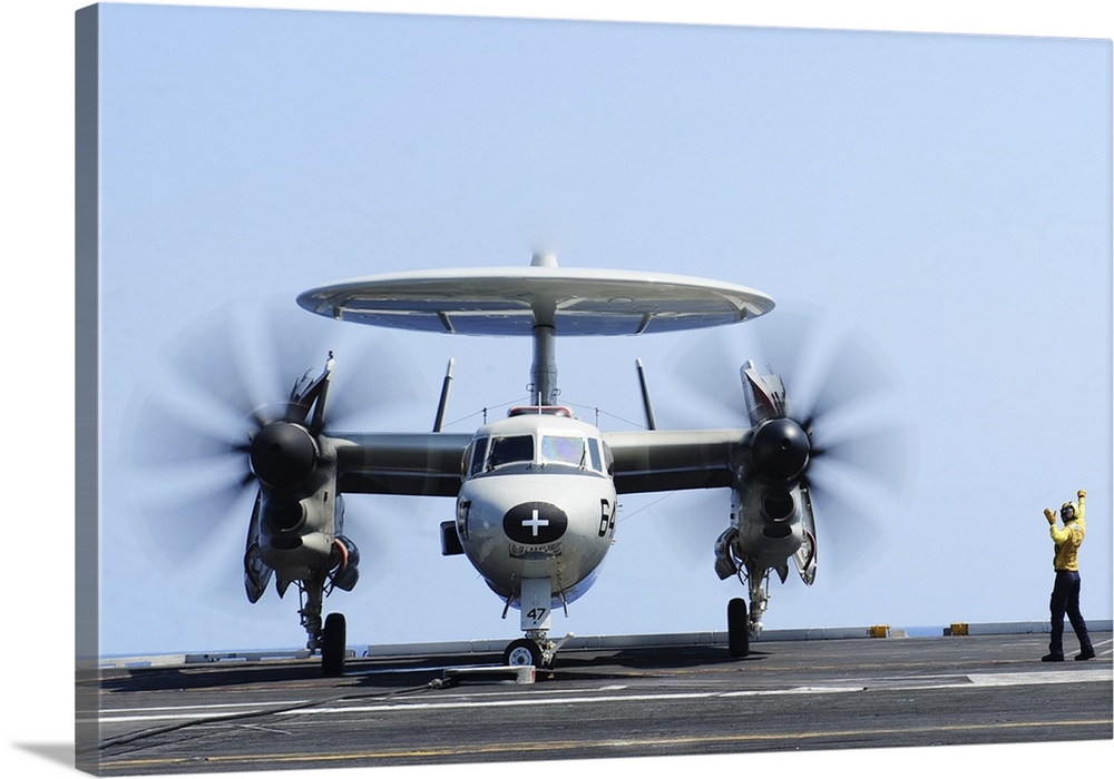 Atlantic Ocean, June 21, 2012 - Aviation Boatswain's Mate directs an E-2C Hawkeye on the flight deck of the aircraft carri...