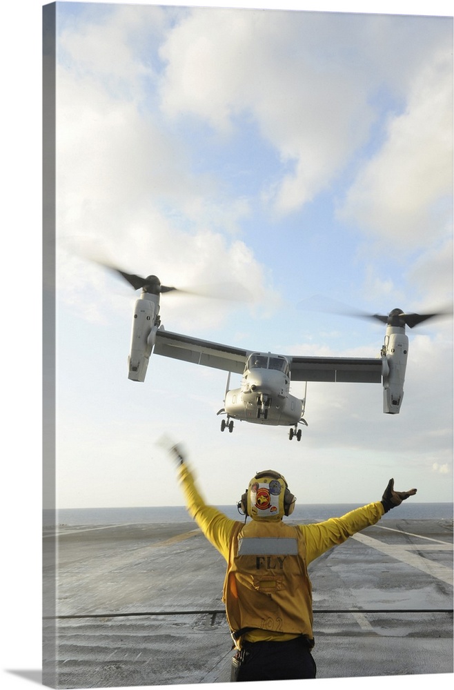 Atlantic Ocean, February 5, 2012 - Aviation Boatswain's Mate signals an MV-22 Osprey to land on the flight deck of the air...