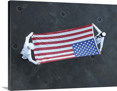 Aviation Ordnancemen Fold The American Flag Aboard USS Theodore Roosevelt