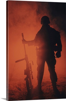 Backlit Silhouette Of Army Sniper With Large Caliber Rifle Standing