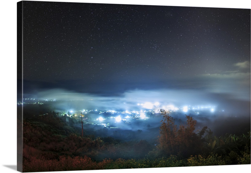 The big dipper and zodiacal light shine above the sea of clouds in Pai, North of Thailand.