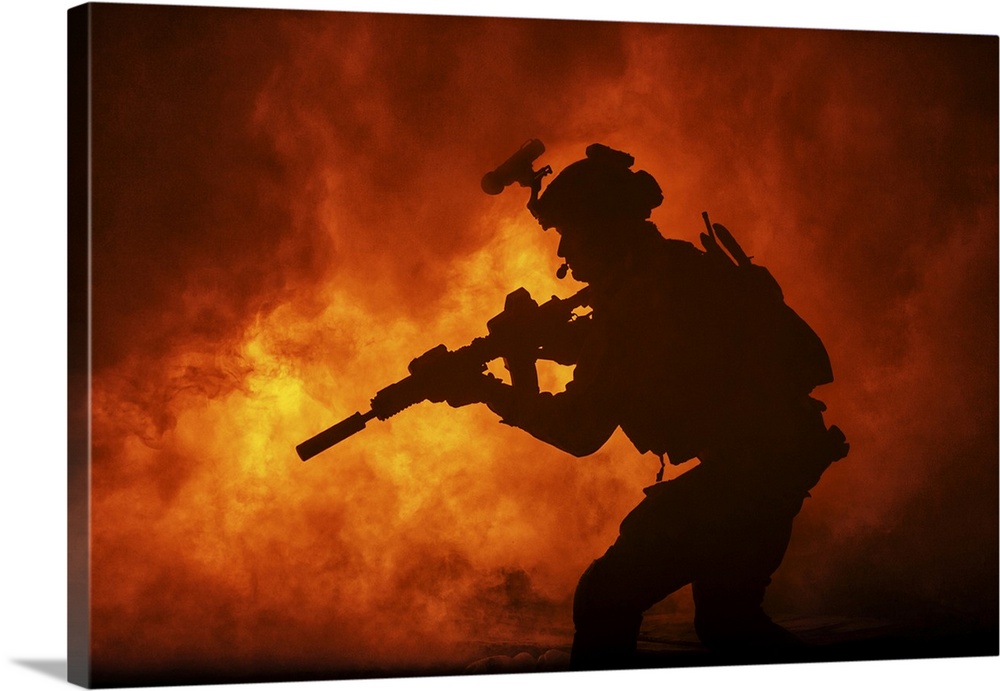 Black silhouette of soldier in the burning fire during a battle operation.