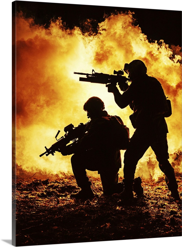 Black silhouettes of a pair of soldiers in the burning fire  during a battle operation.