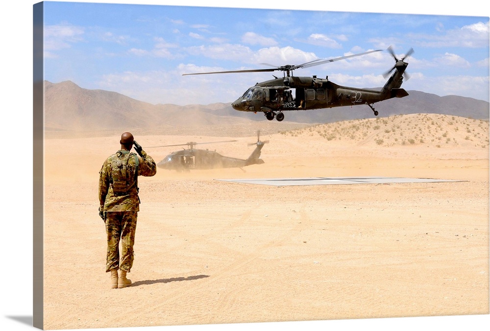 August 4, 2012 - Brigade aviation officer salutes as a UH-60 Black Hawk helicopter lifts off from forward operating base D...