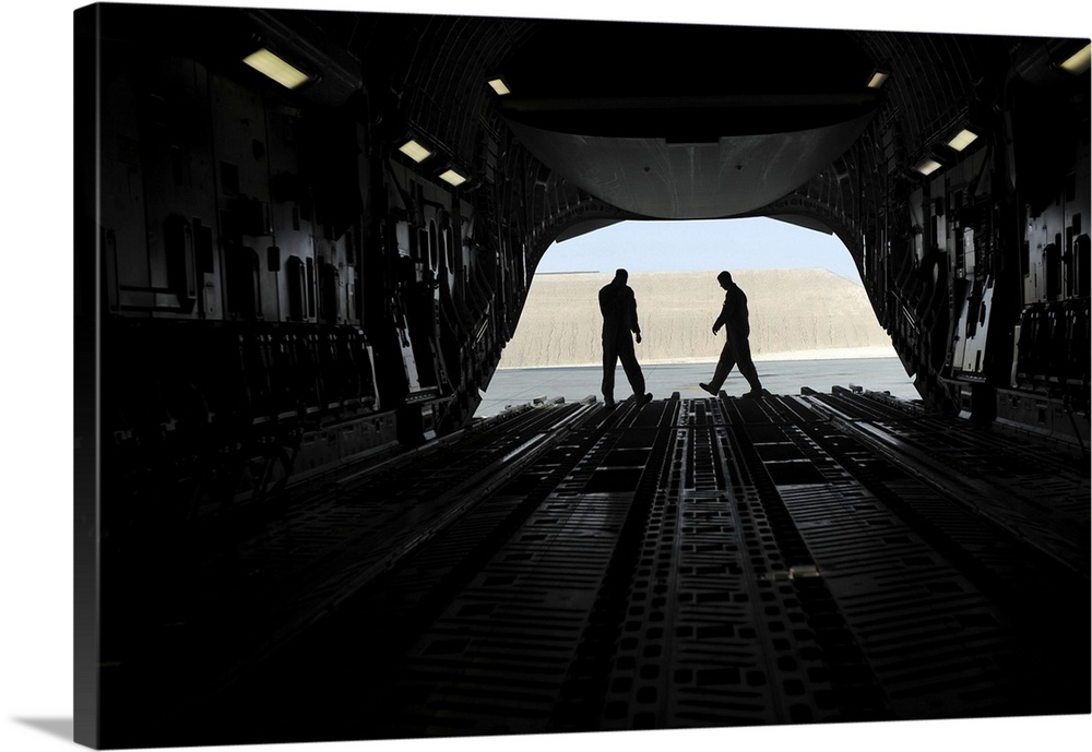 January 20, 2010 - C-17A Globemaster III loadmasters go through prefight checks on the ramp prior to loading cargo for an ...