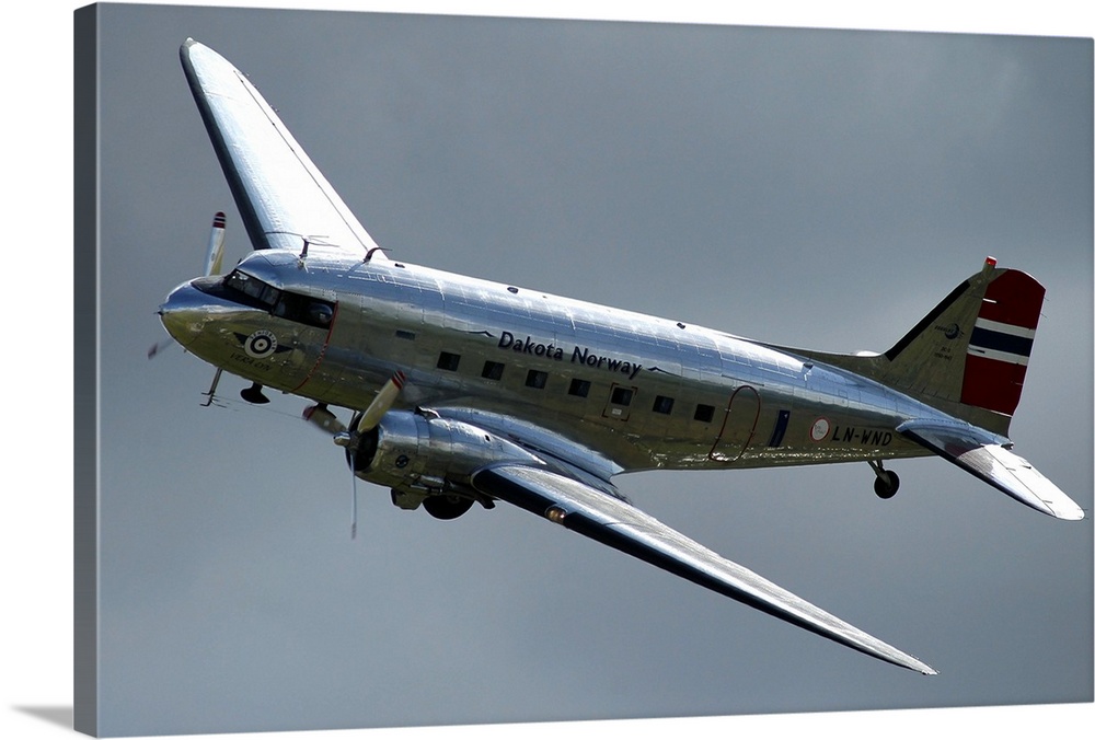 Douglas C-47 Dakota in Norwegian colours during a low pass over the airport at Duxford, England.