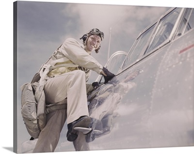 Cadet posing by cockpit of plane at Naval Air Station Corpus Christi, Texas.