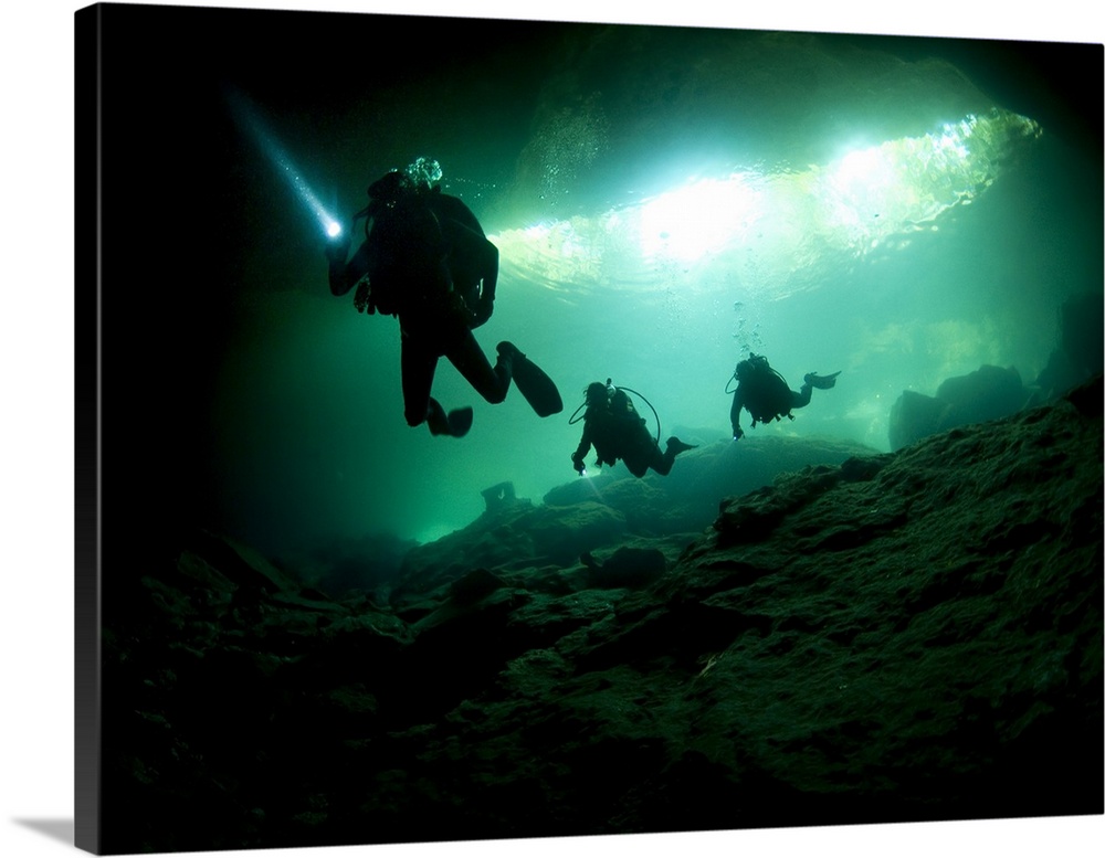 Cavern divers enter cenote system in Mexico's Yucatan Peninsula.
