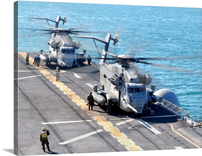 CH-53E Super Stallion helicopters prepare to take off from USS Iwo Jima