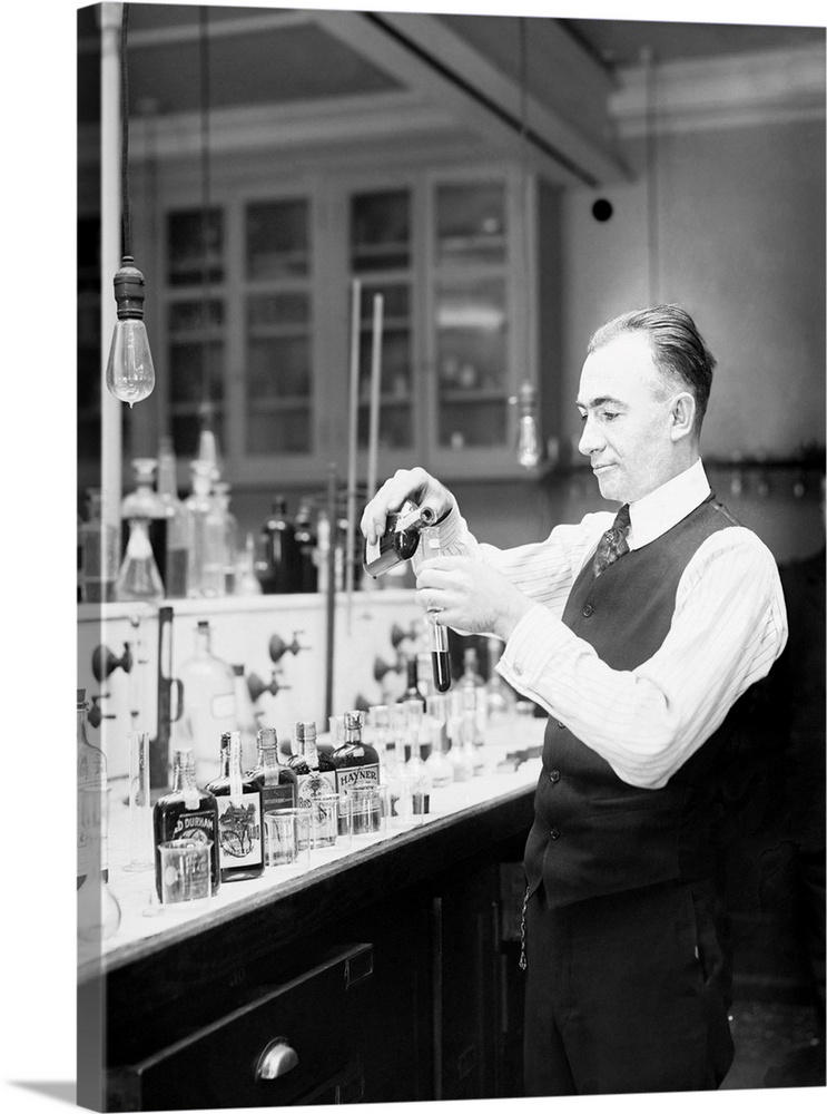 Chemist G. F. Beyer testing a bottle of bootleg liquor during the prohibition era.