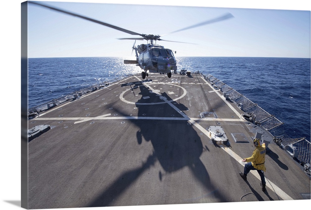 Mediterranean Sea, October 24, 2013 - Cryptologic Technician directs an SH-60R Sea Hawk helicopter to take off from the fl...