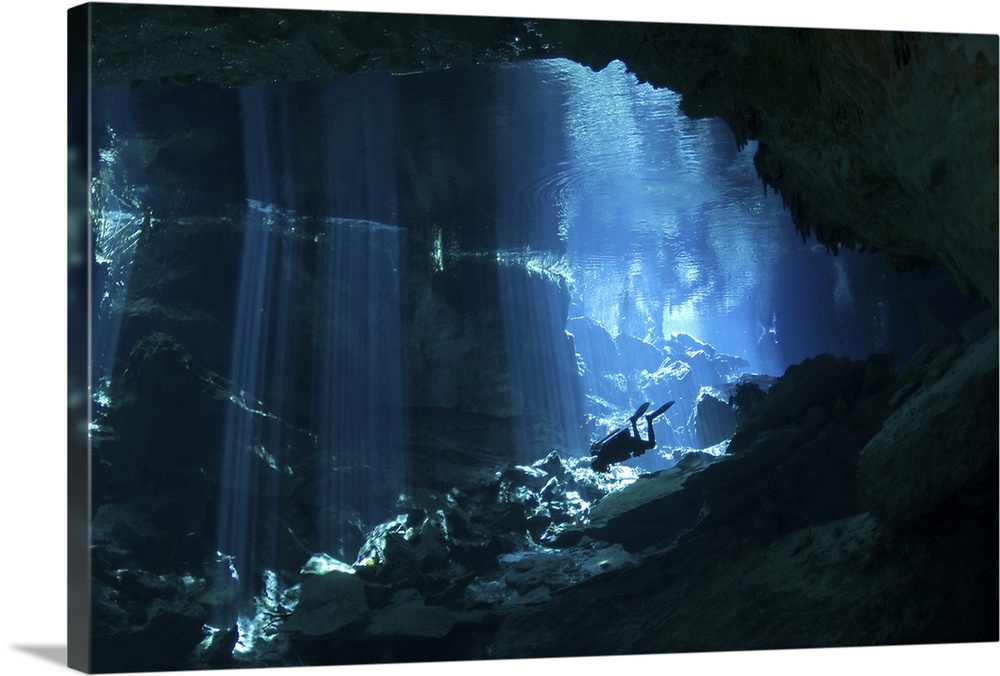 Diver enters the cavern system at Chac Mool cenote in the Riviera Maya area of Mexico's Yucatan Peninsula.