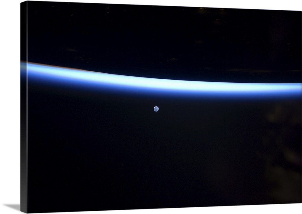 March 6, 2011 - Earth's thin line of atmosphere and a gibbous moon.