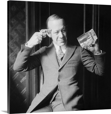 Ernie Hare Holding An Empty Mug And A Pistol, Displaying Distaste For Prohibition Laws