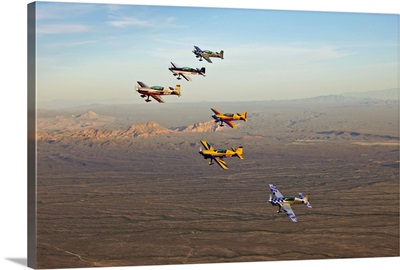 Extra 300 aerobatic aircraft fly in formation over Mesa, Arizona