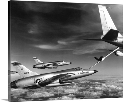 F-105 Thunderchief planes pull up to a KC-135 Stratotanker refueling aircraft, 1966