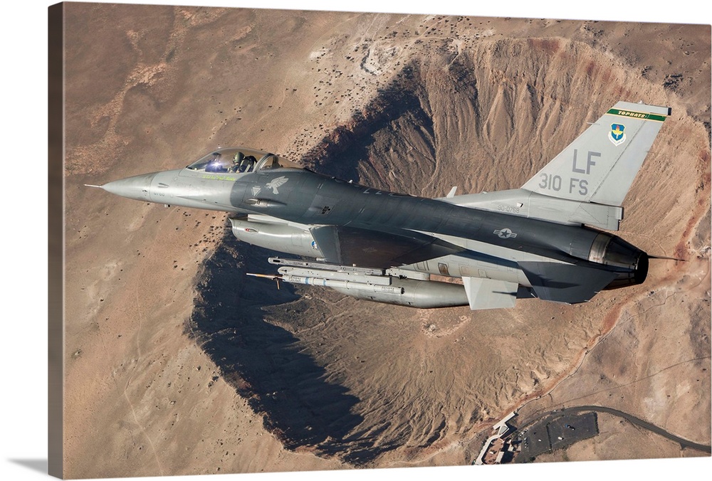 F-16C Fighting Falcon flying above Arizona's Meteor Crater. The F-16C Fighting Falcon is the flagship of the 310th Fighter...