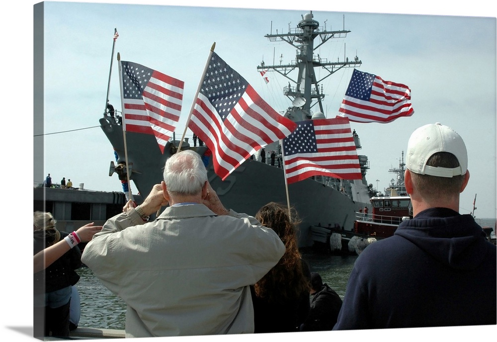 Norfolk, Virginia, March 9, 2006 - Family members wave American flags as they anxiously await their loved ones aboard the ...