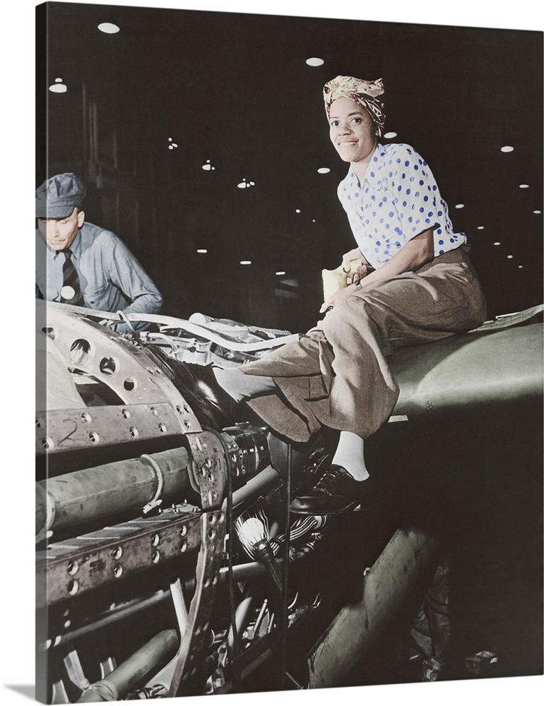 View of a female riveter, part of the wartime labor force, working on the fabrication of an airplane at Lockheed Aircraft ...