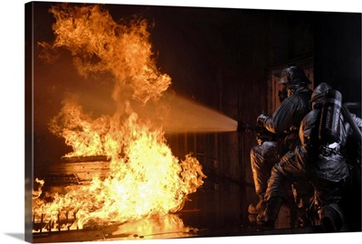 Firefighters extinguish a simulated battery fire