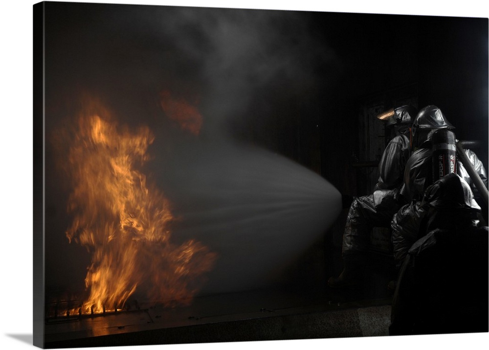 Firefighters extinguish a simulated cargo fire at RAF Mildenhall, England.