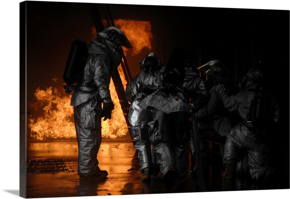 March 8, 2008 - A 48th Civil Engineer Squadron firefighter instructs fellow firefighters to advance towards the simulated ...