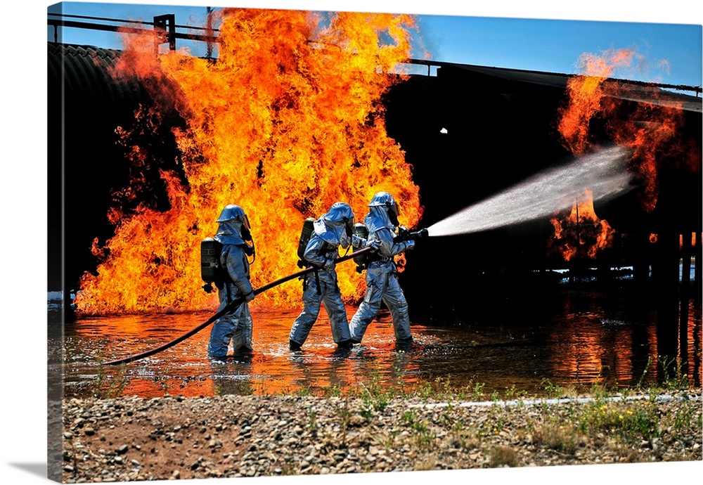 Firefighters work to extinguish a simulated engine fire at Cannon Air Force Base.