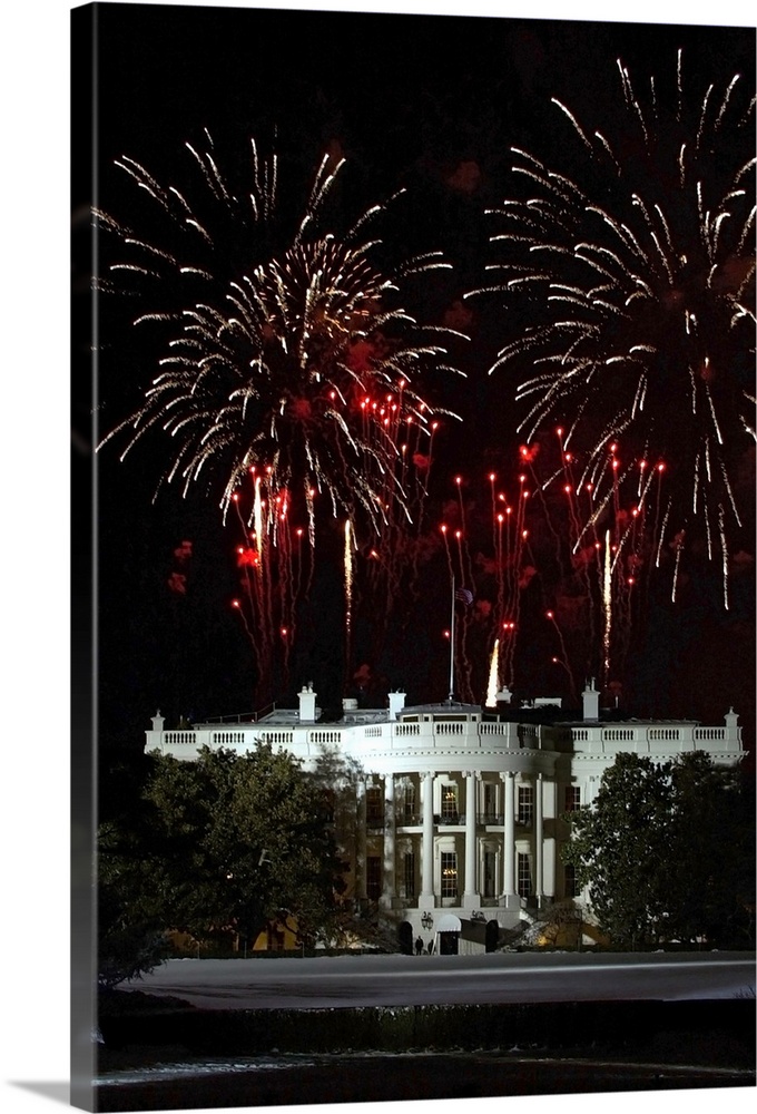 Plumes of firewords explode over top of a lit up White House in Washington, DC.