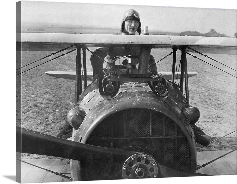 First Lieutenant Eddie Rickenbacker standing on his Spad biplane in France, 1918.